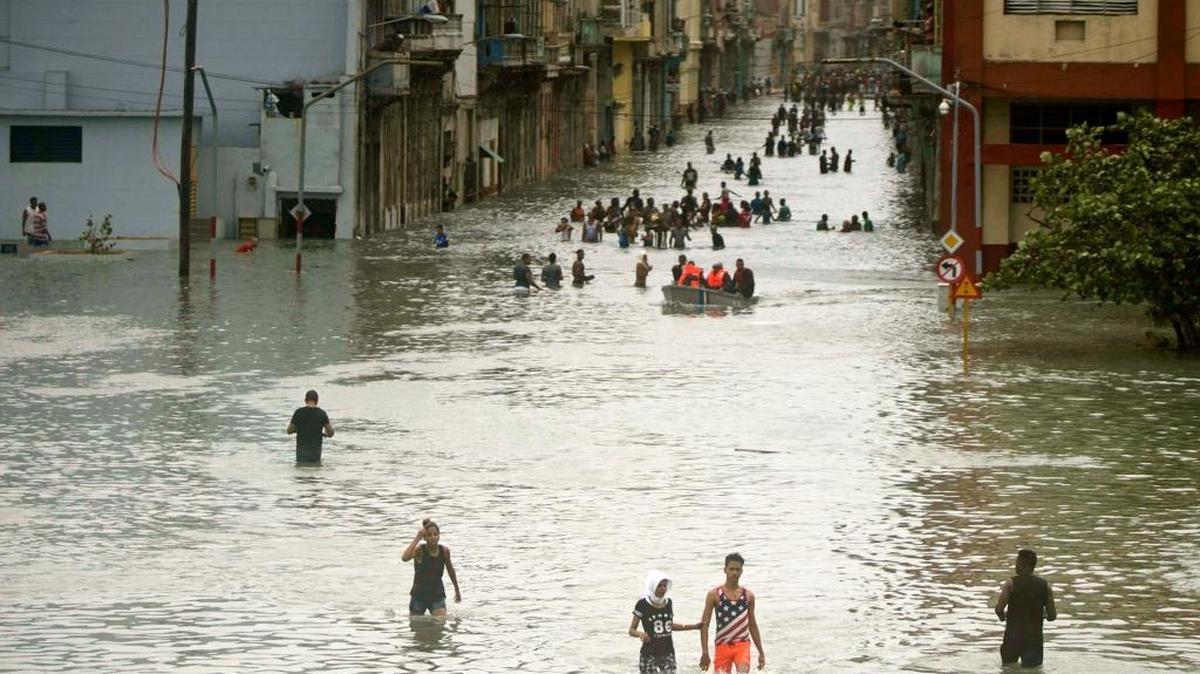People walk through flooded streets in Havana after the passage of Hurricane Irma, in Cuba.