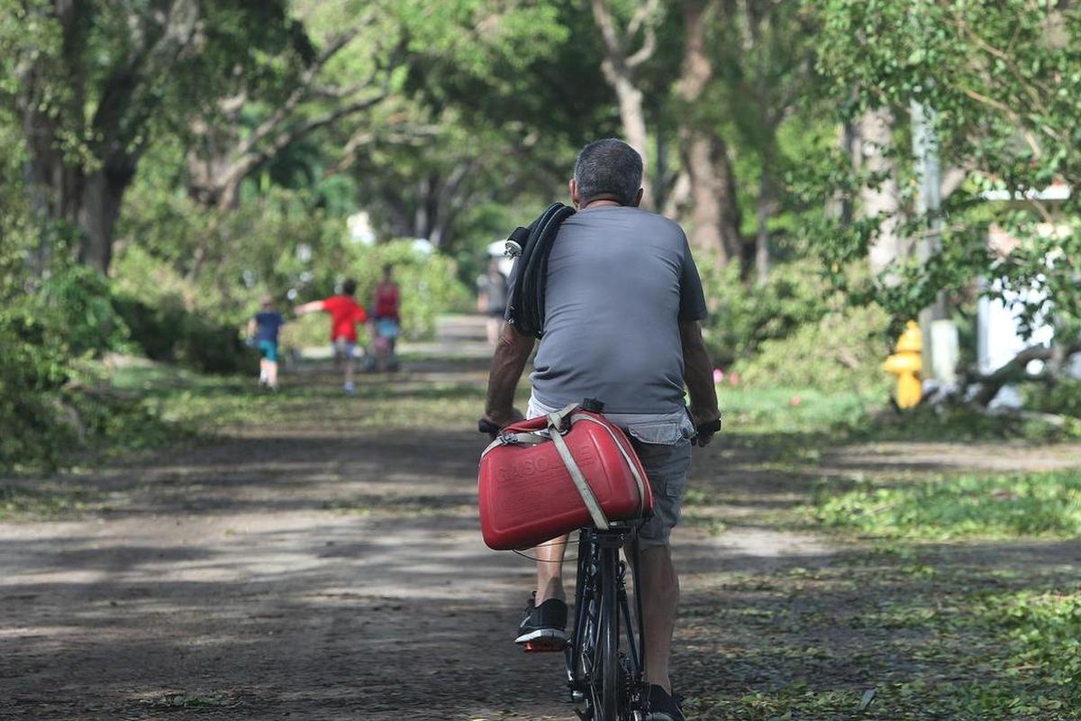 A person on his bicycle looking for gasoline for his generator in the Coral Gables area, in the aftermath of Hurricane Irma on Monday, September 11, 2017.