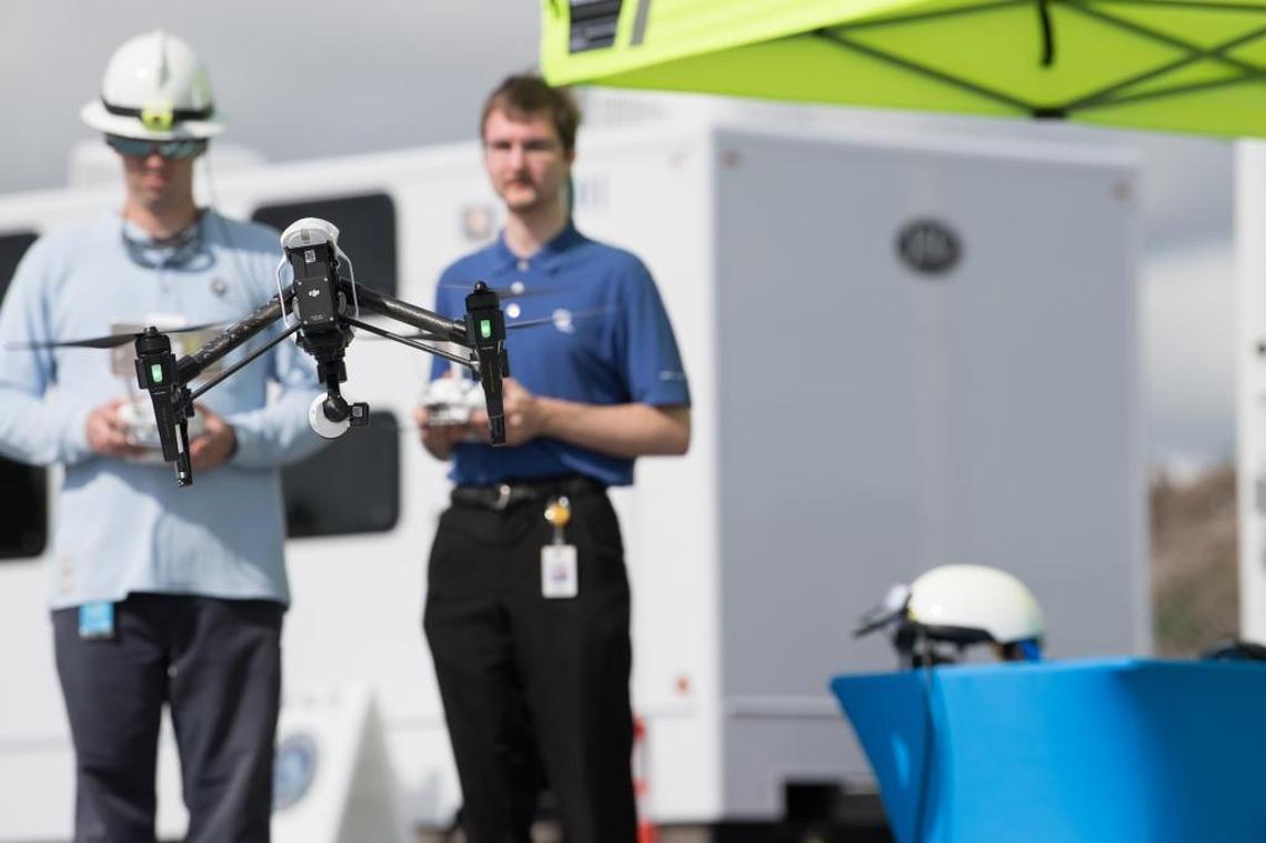 FPL employees Eric Schwartz (left) and Stephen Cross demonstrate an unmanned aircraft system or drone during the company’s annual storm drill at the FPL Command Center in Riviera Beach on May 4, 2017.