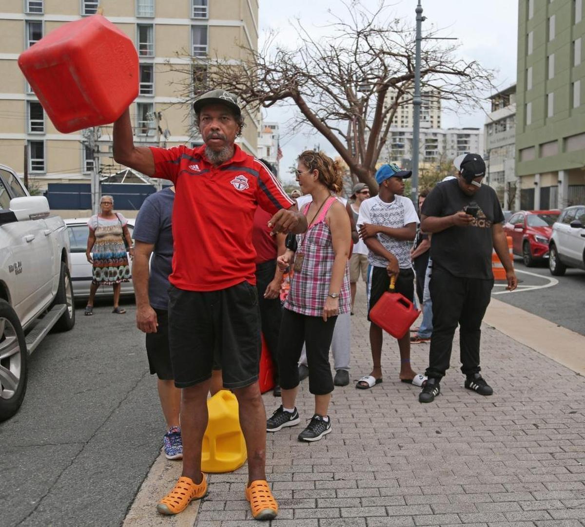 Residents of form lines by car and by foot as they wait for several hours for gas in San Juan on Friday.