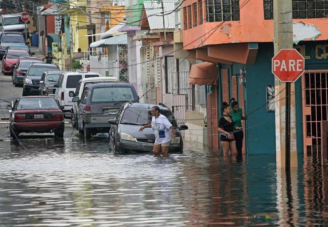 Residents deal with navigating high water throughout San Juan as Hurricane Maria left many streets flooded and blocked by fallen power lines, trees, and debris while Puerto Rico tries to recover from the Category 4 storm on Thursday.