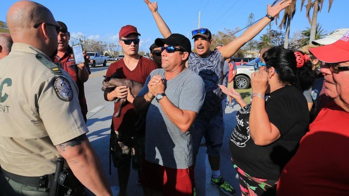 Keys residents plead with officers to let them through the police check point at mile marker 73 on Wednesday, September 13, 2017. Police threatened the Keys residents with arrest and their cars towed if they would not leave the area by 7:45 p.m. Police said they were acting on orders by Governor Rick Scott. On Saturday morning, Monroe County announced that all Monroe County residents will be able to return to the Keys Sunday. This includes those who live in severely hard-hit areas of the Lower Keys between Key West and Marathon.