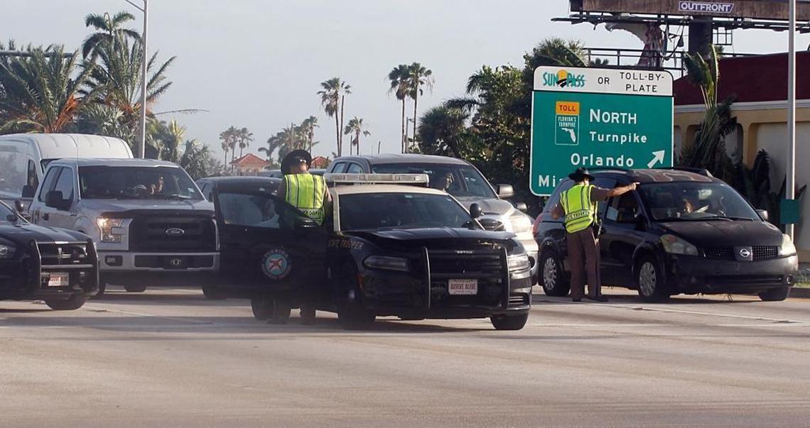 Florida state troopers redirect traffic at the intersection of Southwest 344th Street and U.S. 1 in Homestead. Authorities were blocking access to the Florida Keys a day after Hurricane Irma battered the islands.