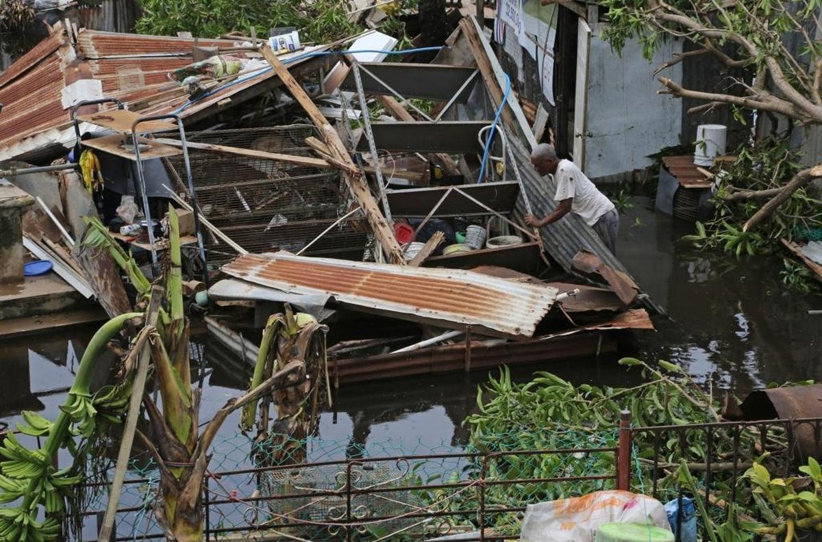 Víctor Lozada searches for items that can be salvaged from his shed, which was completely destroyed by Hurricane Maria’s wind and water in Loíza.