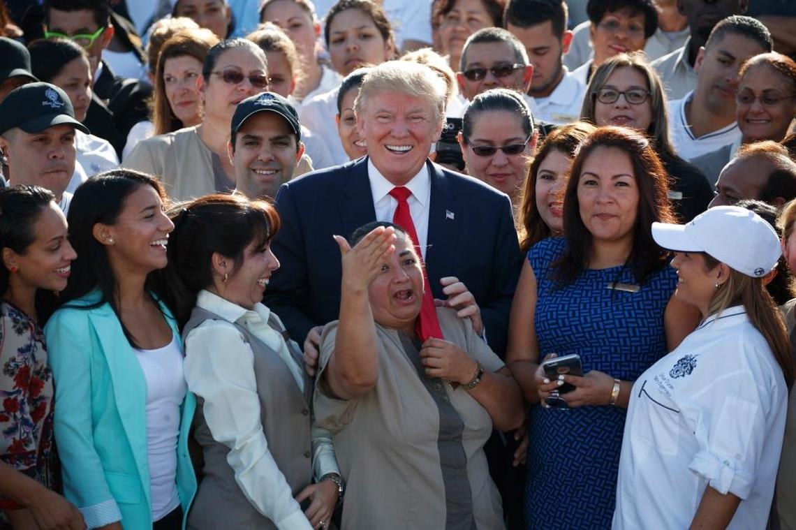 Republican presidential candidate Donald Trump poses for photographs during an campaign event with employees at Trump National Doral, Tuesday, Oct. 25, 2016, outside of Miami