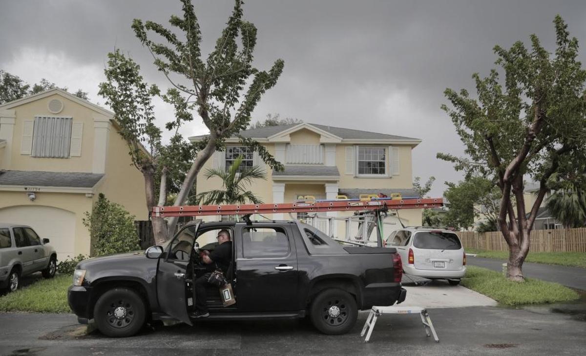 Catastrophic claims specialist Eric Kline works in his truck on a claim by client Myriam Diaz at her home in Kendall. Her home sustained damage by Hurricane Irma.