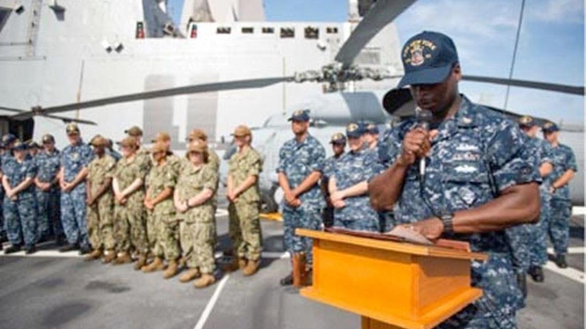Senior Chief Petty Officer Demetrius Fitts of Jacksonville, Florida, a culinary specialist, reads remarks on the flight deck aboard the amphibious transport dock ship USS New York during a 9/11 Remembrance Ceremony as the ship prepares for potential humanitarian relief efforts off the coast of Florida on Sept. 11, 2017. Part of the ship was forged from steel taken from New York City’s destroyed World Trade Center.