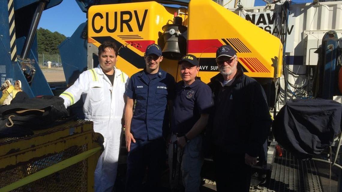 NTSB investigators working on the El Faro case stand before the remotely operated vehicle that may be the last best hope for determining exactly why the ship sank Oct. 1.