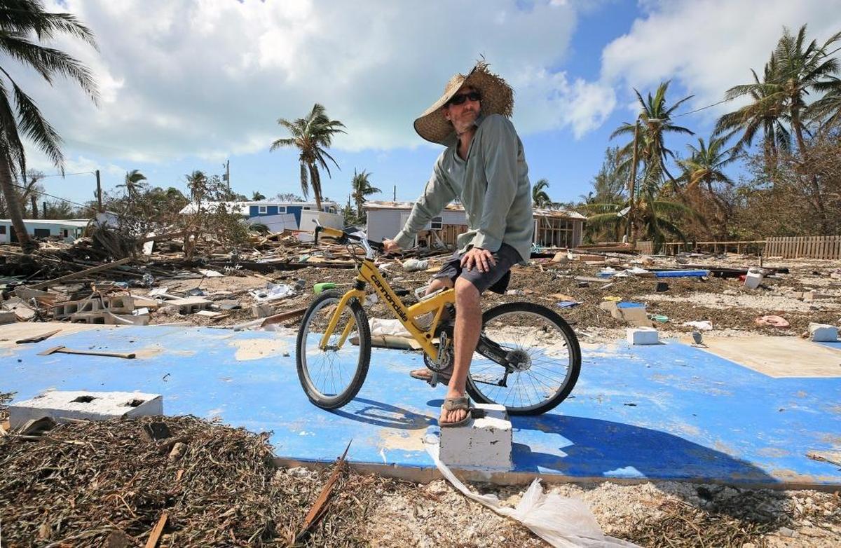 Billy Quinn sits on his bike and the concrete slab where his trailer once stood at the Seabreeze trailer park along the Oversees Highway in the Florida Keys.