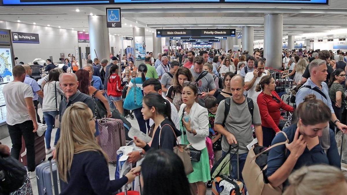 Thousands of travelers pack into Miami International Airport as they wait in line to leave Miami on Thursday, Sept. 7 ahead of Hurricane Irma.