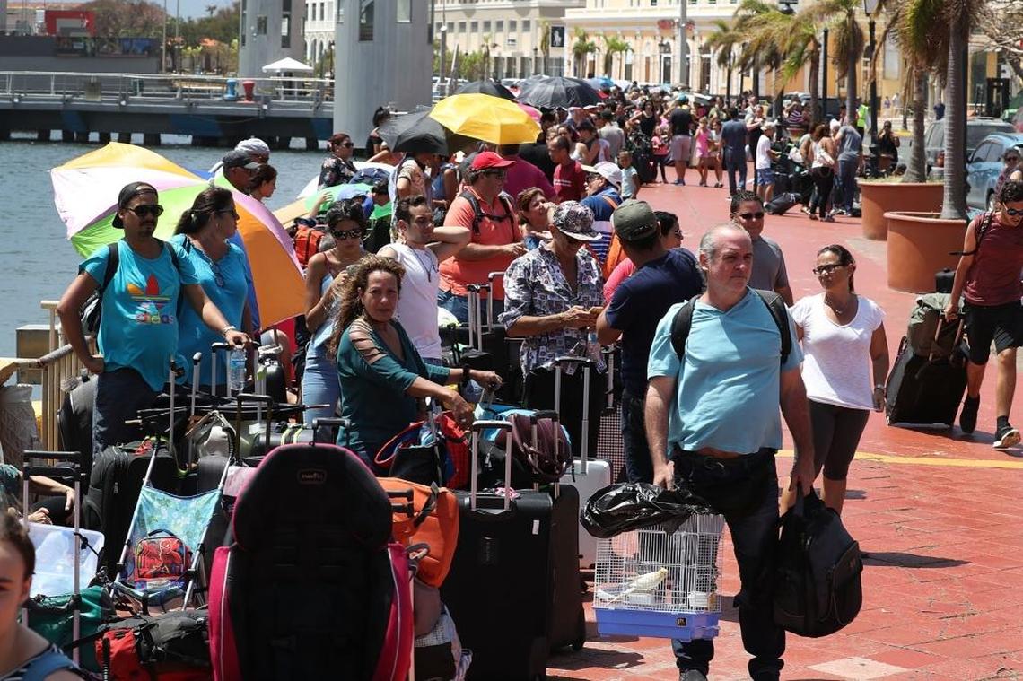 People line up to get on a Royal Caribbean International’s Adventure of the Seas, a relief boat that is sailing to Fort Lauderdale, Florida with evacuees that are fleeing after the island was hit by Hurricane Maria on Sept. 28 in San Juan, Puerto Rico. Puerto Rico experienced widespread damage including to most of the electrical, gas and water grid as well as agriculture after Hurricane Maria, a Category 4 hurricane, passed through.