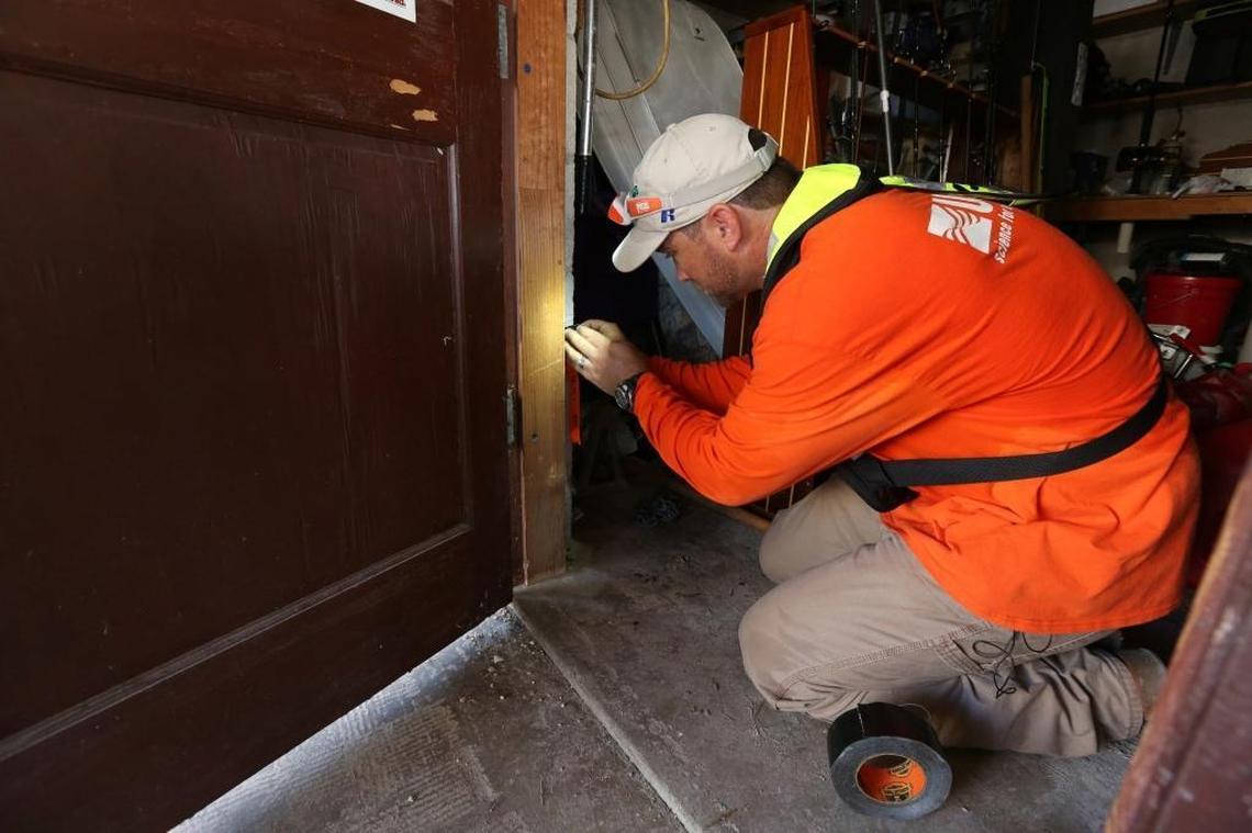 Don Hampton, a hydrologic technician with the U.S. Geological Survey, measures a high water mark he and team member David Byers discovered in the downstairs utility room of a house on Big Pine Key. The USGS is racing to document the marks to better measure Hurricane Irma’s storm surge before they are erased in cleanup efforts.