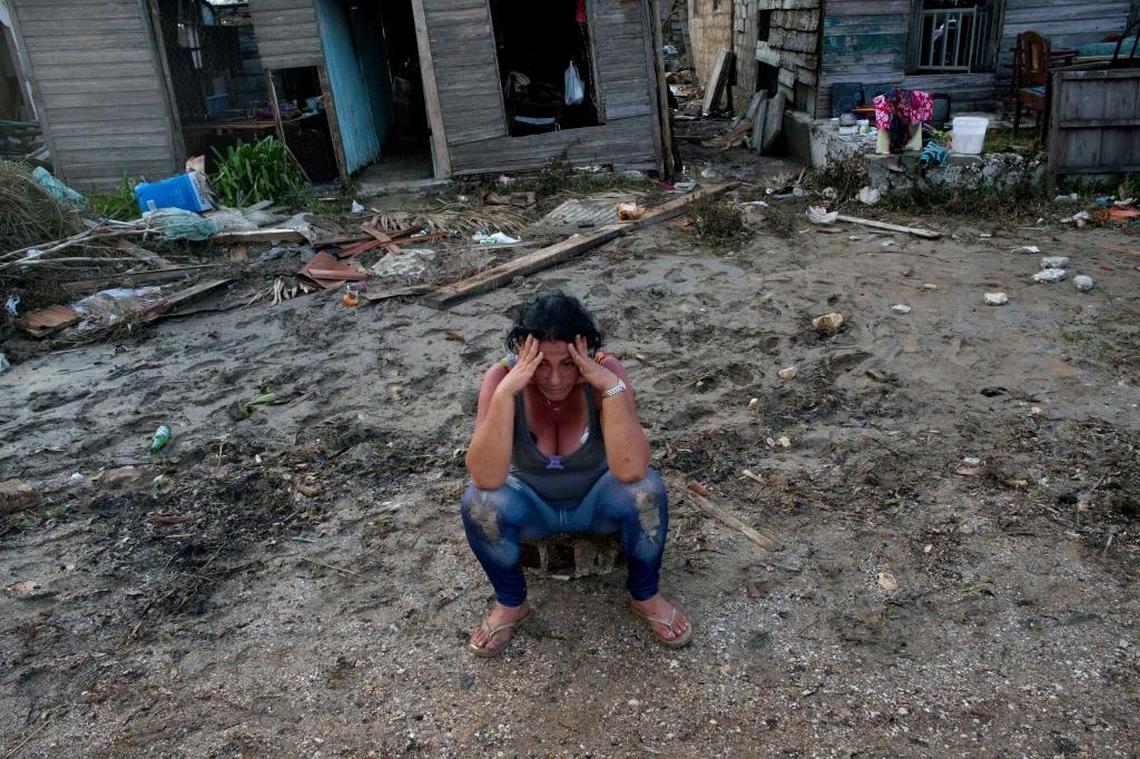 A despondent Mariela Leon sits in front of her flood-damaged home after the passing of Hurricane Irma, in Isabela de Sagua, Cuba on Sept. 11. Cuban state media reported 10 deaths despite the country’s usually rigorous disaster preparations.