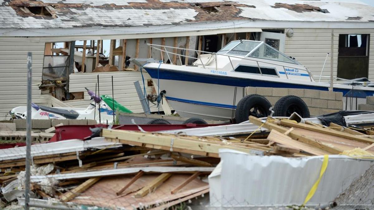 A pleasure boat stands next to a destroyed home after the passing of Hurricane Irma, in Culebra, Puerto Rico, Thursday, Sept. 7, 2017. About a million people were without power in the U.S. territory after Irma passed just to the north, lashing the island with heavy wind and rain. Nearly 50,000 also were without water.