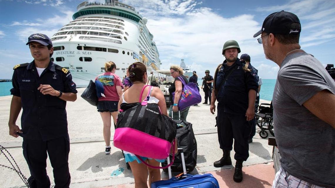 This photo provided by the Dutch Defense Ministry on Sunday, Sept. 10, 2017, shows people walking toward a cruise ship anchored on St. Maarten, after the passage of Hurricane Irma. Irma cut a path of devastation across the northern Caribbean, including this island that is split between French and Dutch control.