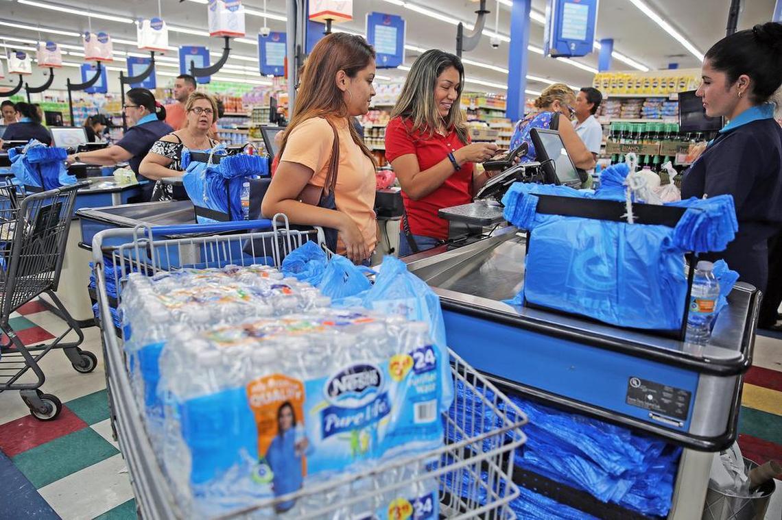 A customer and her daughter stock up on water for hurricane preparations at a Presidente Supermarket on Calle Ocho in Little Havana on Monday, September 4, 2017.