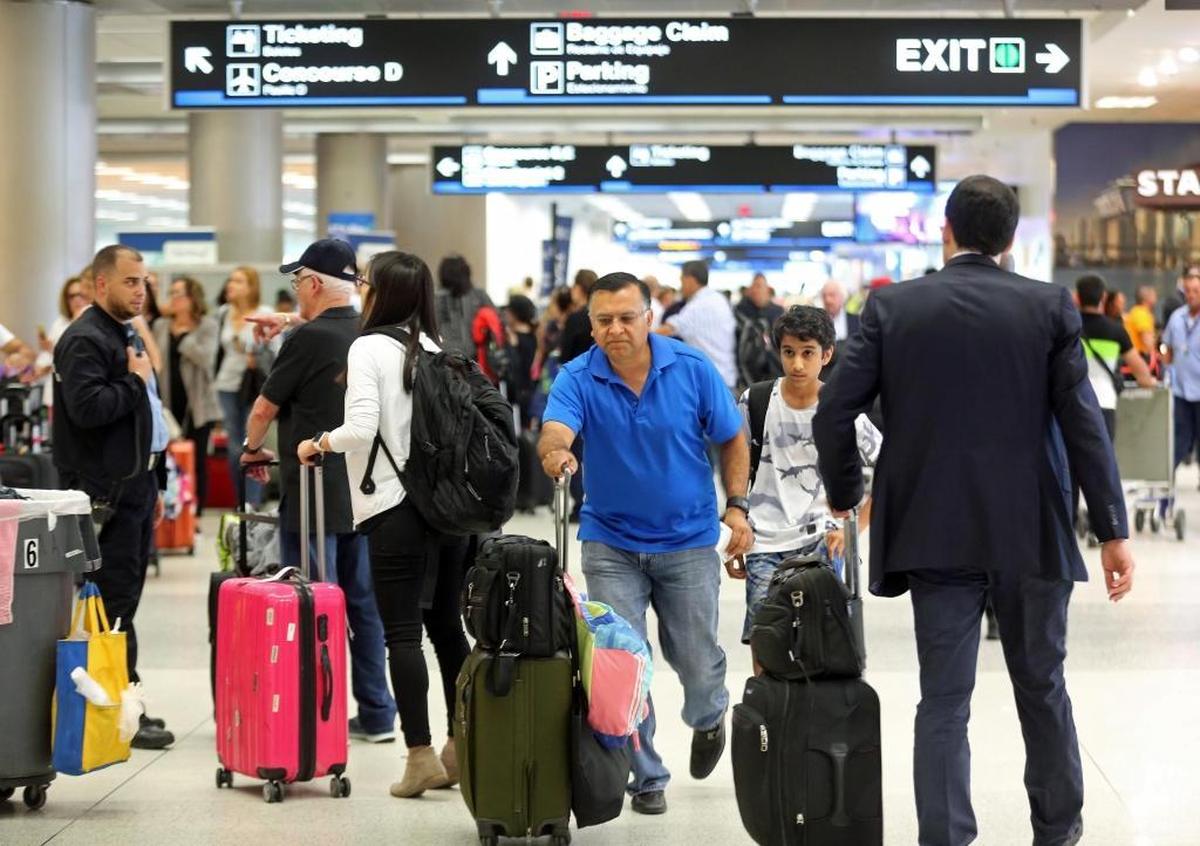 Thousands of travelers pack into Miami International Airport as they wait in line to leave Miami on Thursday, Sept. 7 ahead of Hurricane Irma.