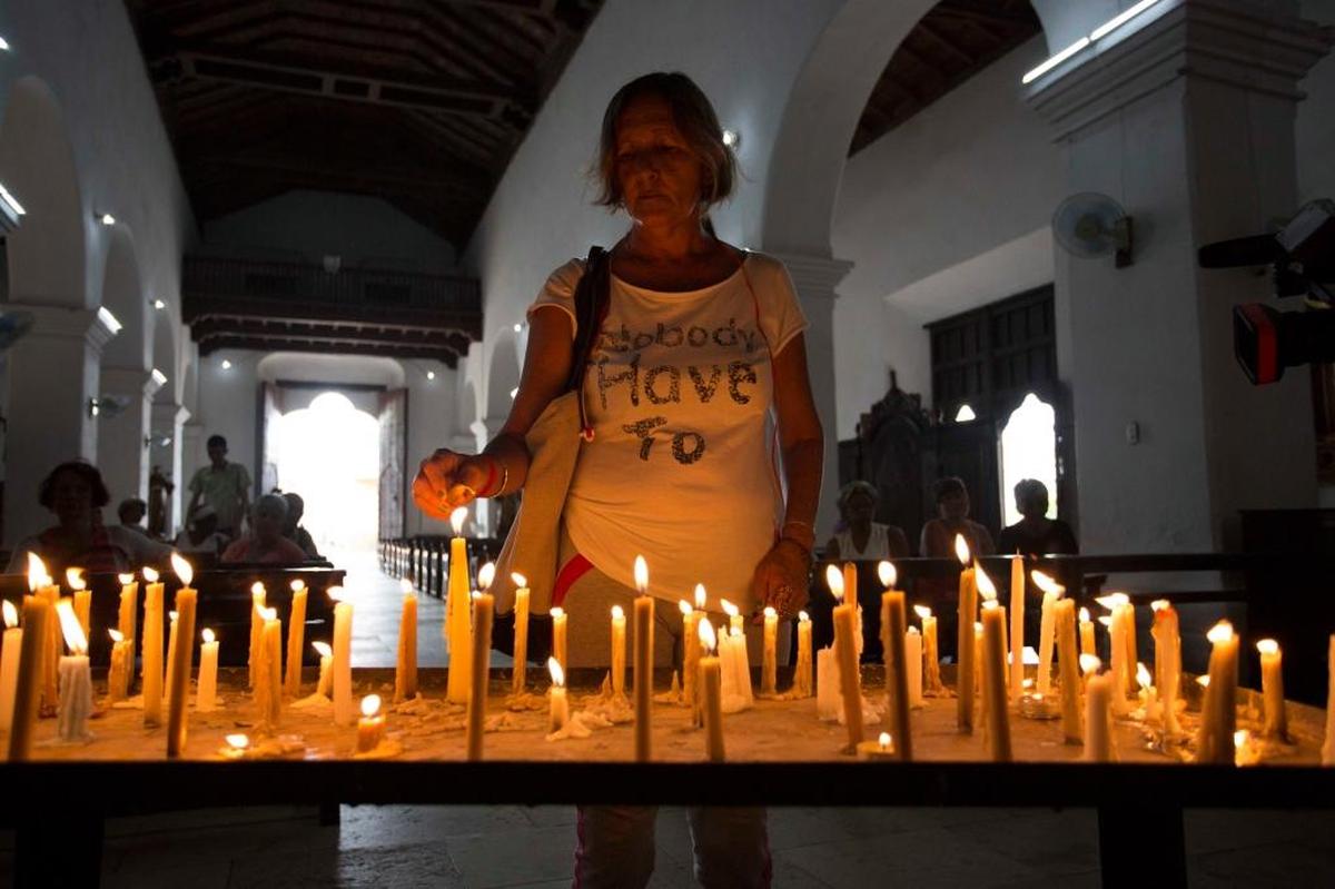 A woman prays at a church for protection against Hurricane Irma, in Caibarien, Cuba, on Friday. Irma struck the same day that Cuba celebrated the feast of Our Lady of Charity of El Cobre, the island’s patron saint.