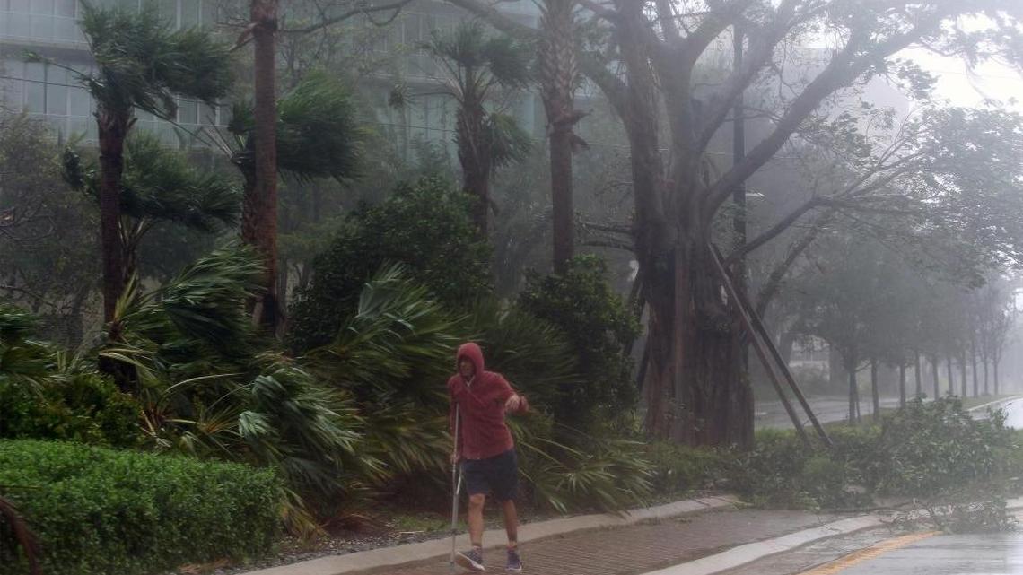 A man walks along 27th Avenue and South Bayshore Drive during winds and rains caused by Hurrice Irma on Sunday, Sept. 10, 2017.