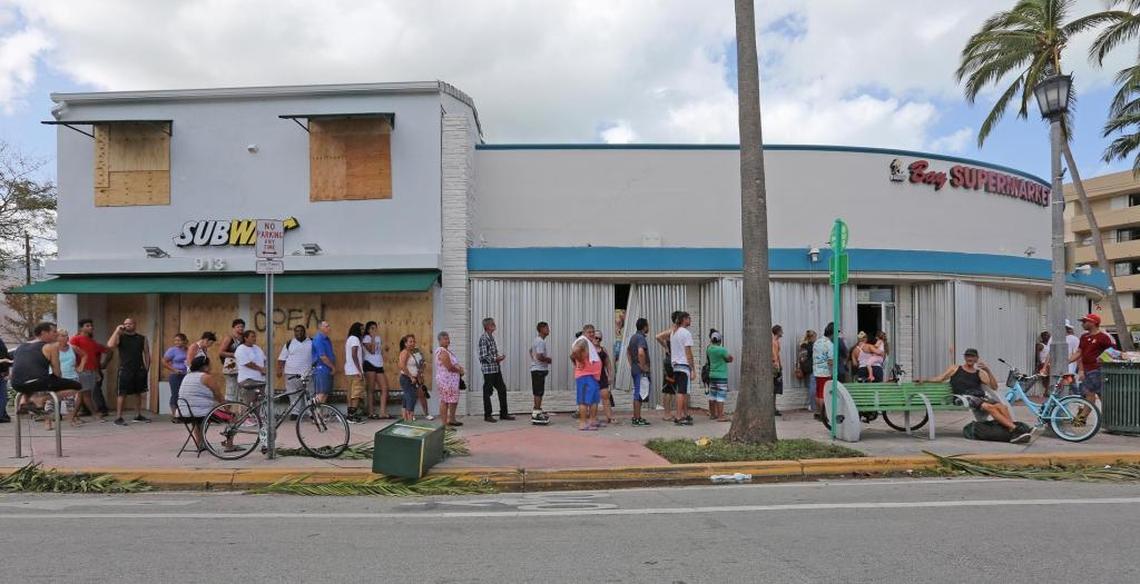 About 50 people line up to purchase basic food and lots of beer at Bay Supermarket in Normandy Isle in Miami Beach on Monday, September 11, 2017.