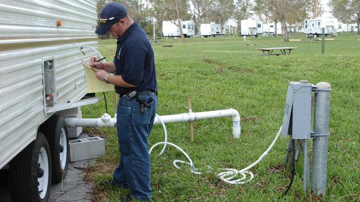 A FEMA disaster assistance employee works to complete the final checklist for one of the 57 FEMA trailers located at C.B. Smith Park in Pembroke Pines. The new FEMA trailers were set up for victims of Hurricane Wilma in 2005.