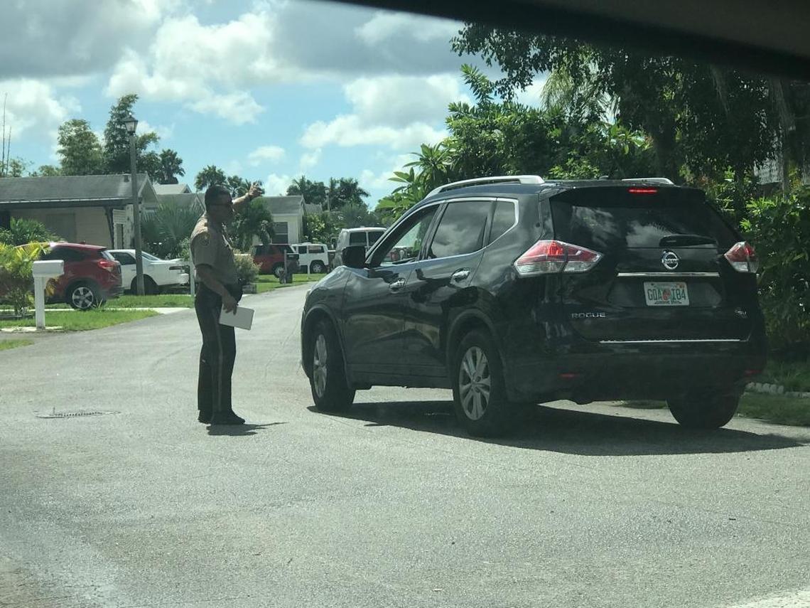 A Miami-Dade police officer talks to a resident at the Goldcoaster mobile home park between Homestead and Florida City.