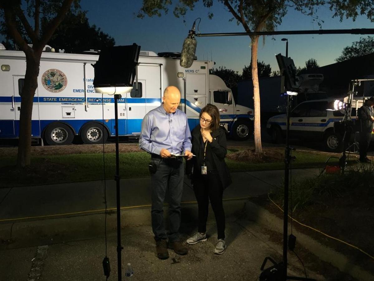 Gov. Rick Scott reviews his talking points on the state's preparations for Hurricane Irma with his press secretary, Lauren Schenone, in between national morning show appearances outside the state Emergency Operations Center in Tallahassee on Sept. 9, 2017.