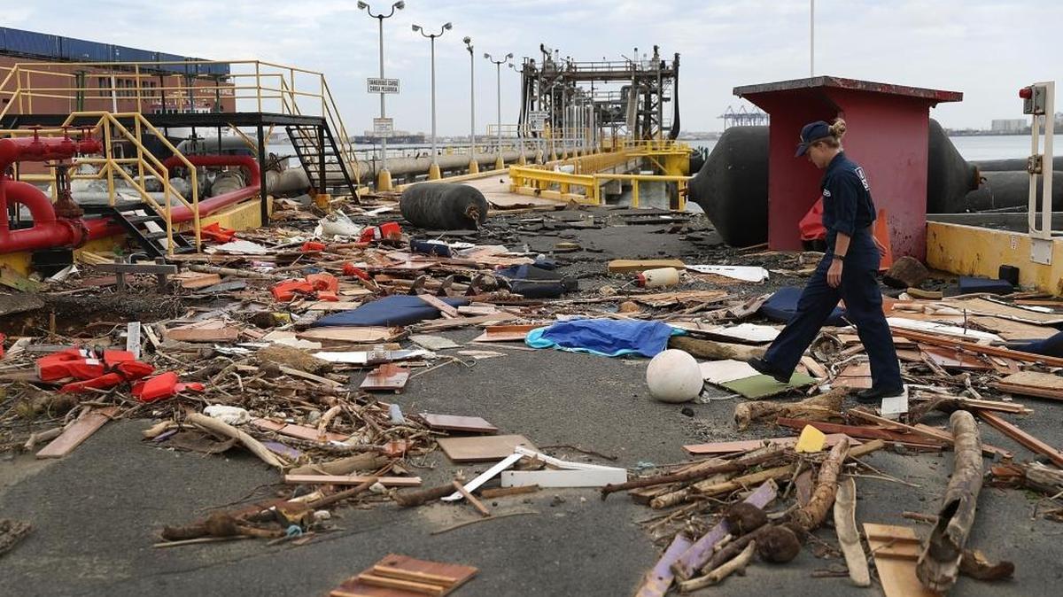 U.S. Coast Guard MST-2 Annaliese Ennis surveys the damage to an oil dock after Hurricane Maria passed through the area on September 23, 2017 in San Juan, Puerto Rico. Puerto Rico experienced widespread damage after Hurricane Maria, a category 4 hurricane, passed through.