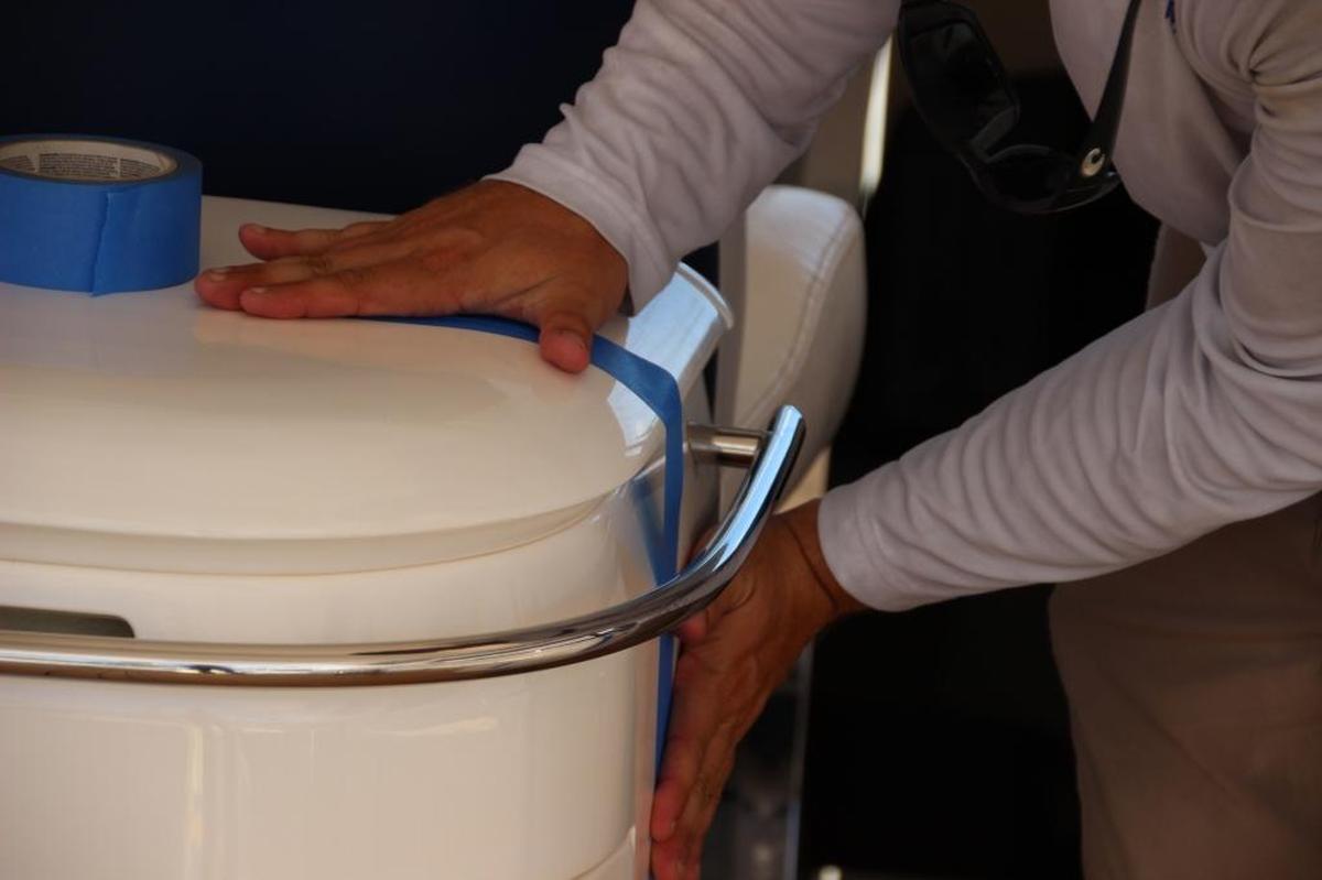 Blue masking tape covers any doors or openings to protect boats as much as possible at Miamarina in Bayside on Thursday. Boat owners and crew members prepared their boats ahead of Hurricane Irma.