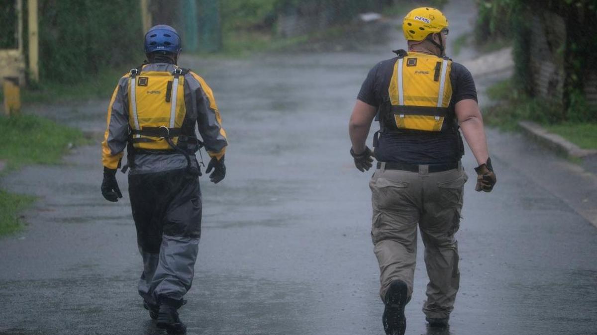 Julio Feliciano, left, and Adrian Colon both rescue staff members from the Municipal Emergency Management Agency toured the streets of the Matelnillo community searching for citizens in distress during the passage of hurricane Irma through the northeastern part of the island in Fajardo, Puerto Rico, Wednesday, September 6, 2017. The US territory was first to declare a state of emergency las Monday, as the National Hurricane Center forecast that the storm would strike the Island Wednesday.
