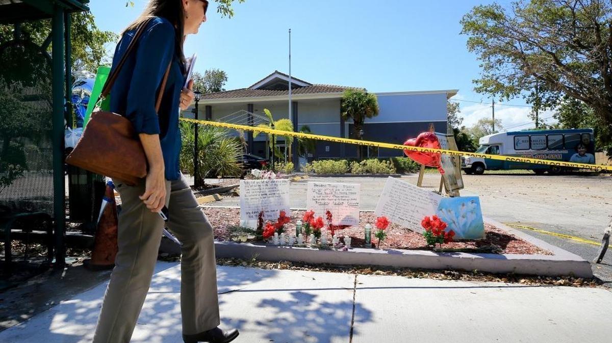 Dawn Schonwetter stops to look at a memorial of flowers and messages left on the sidewalk of the Rehabilitation Center of Hollywood Hills on Saturday, September 16, 2017. Eight people died at the nursing home in the aftermath of Hurricane Irma.