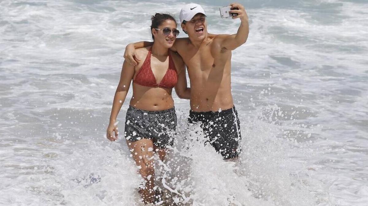 Beck Jumaev and Selina Garcia of Miami taking selfies at Haulover Beach on Tuesday. Later Tuesday, the state warned that the water quality may have been affected by Hurricane Irma and recommended against swimming along the Miami-Dade coast.