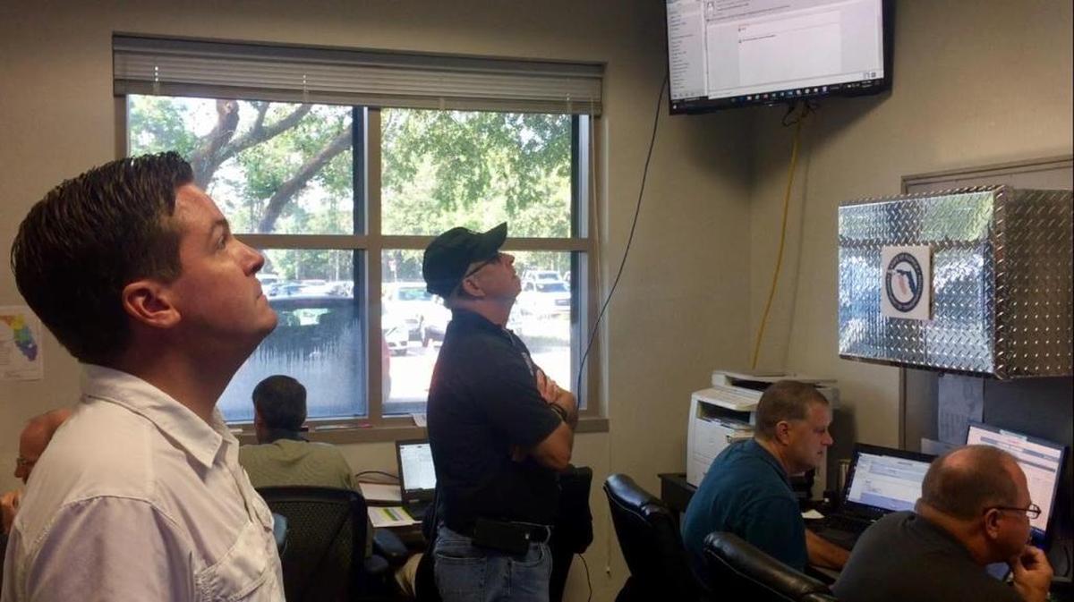 Mike Dew, director of the Florida Department of Transportation, watches evacuation traffic on state roadways on a bank of video monitors in the state Emergency Operations Center in Tallahassee on Friday, Sept. 8, 2017