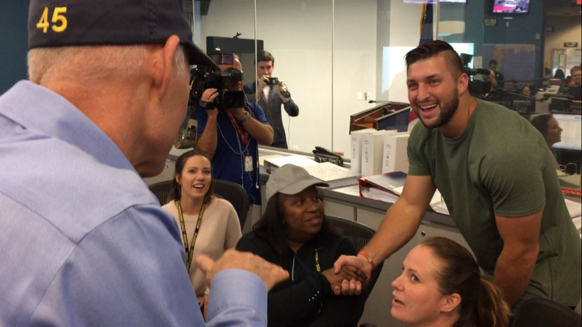 Former NFL and University of Florida star quarterback Tim Tebow, of Jacksonville, takes a photo with state workers during a visit to the state Emergency Operations Center in Tallahassee on Sept. 12, 2017. Tebow visited with Gov. Rick Scott to thank the state workers for their preparation and response efforts to Hurricane Irma. Scott, left, joked to the workers: “You’re all Gator fans, by the way.” Kristen M. Clark / Herald/Times Tallahassee bureau.