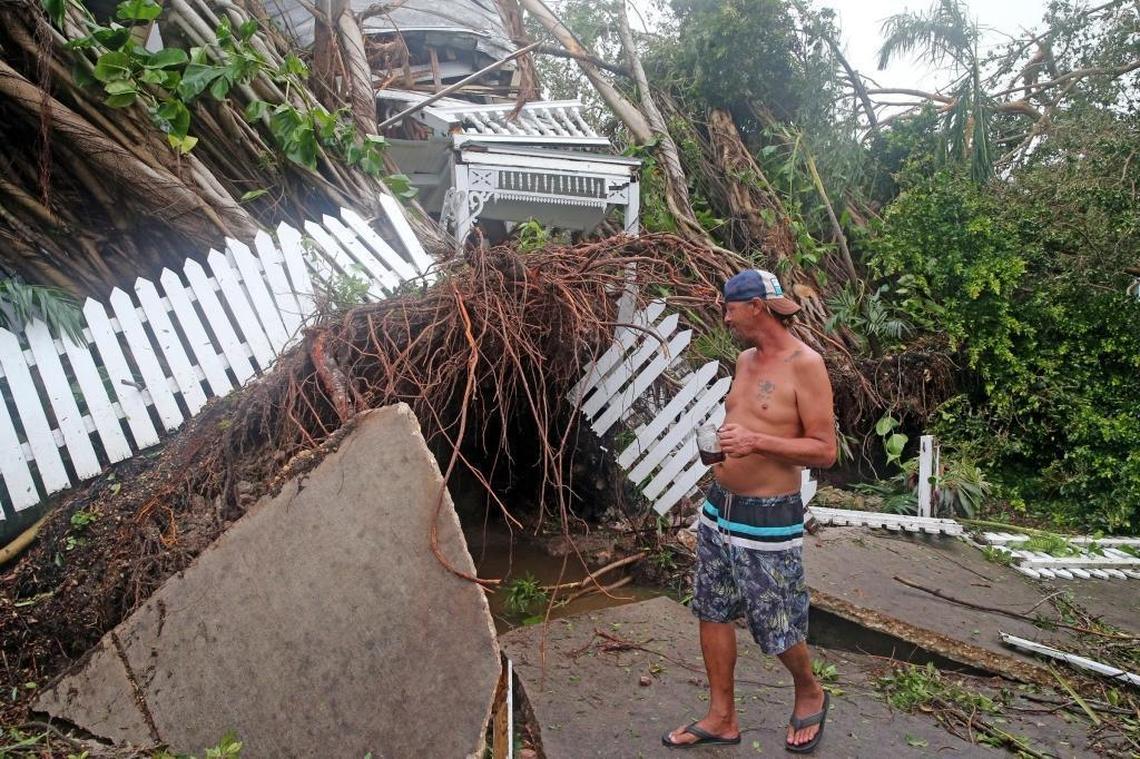 Robert Phillips looks at a house on Williams Street in Key West that was crushed as Hurricane Irma passed over the island, September 10, 2017.