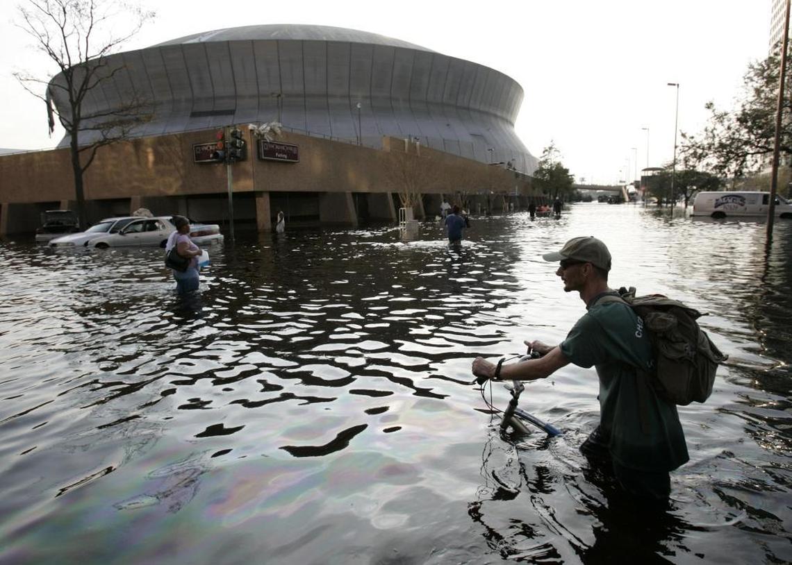This Aug, 31, 2005 file photo shows a man pushing his bicycle through flood waters near the Superdome in New Orleans after Hurricane Katrina left much of the city under water.