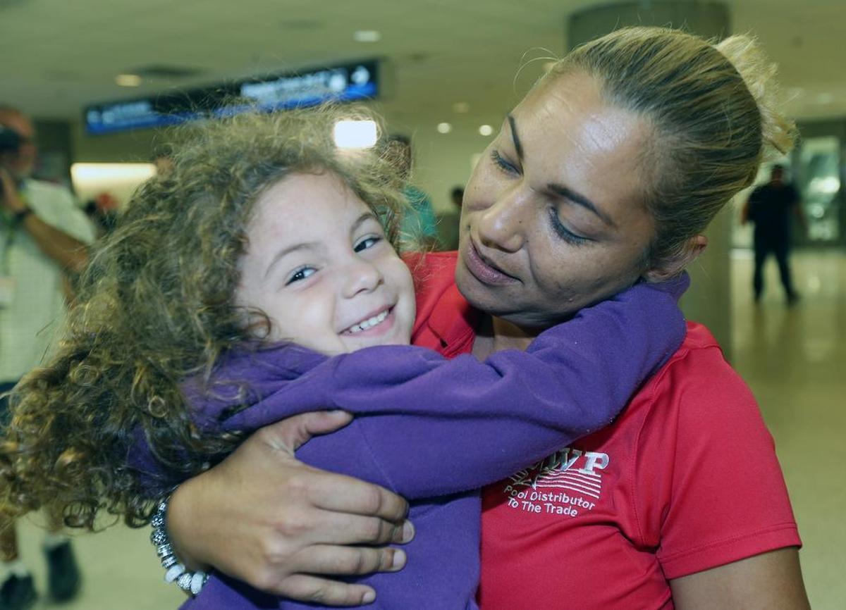 Mara Moreno hugs her granddaughter Wilyanielis Alvarez, 3, at Miami International Airport after the child arrived from Puerto Rico. Wilyanielis’ mother Stephanie Santiago decided to flee with her children after the storm.