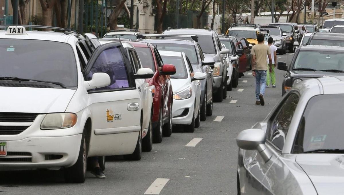 Residents of form lines by car and by foot as they wait for several hours for gas in San Juan on Friday.