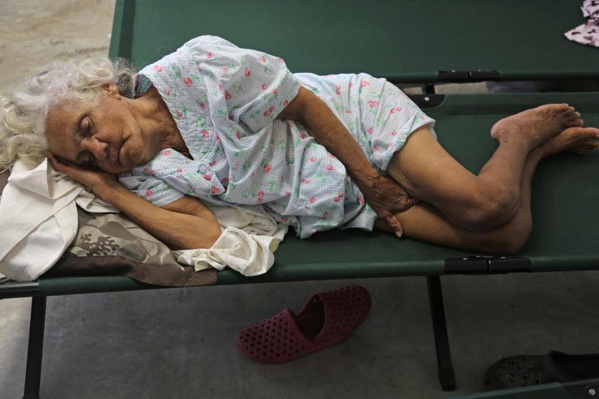 Isabela evacuee Angelica Hernandez, 70, sleeps on her cot after fleeing the possible breech of the Guajataca dam and finding shelter at Francisco Mendoza High School in the center of Isabela, Puerto Rico on Saturday, September 23, 2017.