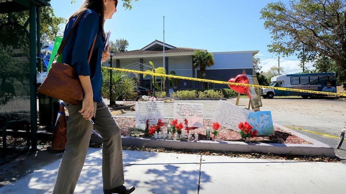 Dawn Schonwetter stops to look at a memorial of flowers and messages left on the sidewalk of the Rehabilitation Center at Hollywood Hills on Saturday, Sept. 16, 2017. Eight residents of the nursing home died in the wake of Irma.