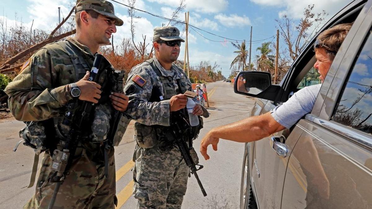 Pvt. Nicholas Radler and Sgt. Michael Serrano with the Florida Army National Guard check IDs as residents returned home to the Lower Keys on Sunday, Sept. 17, 2017.