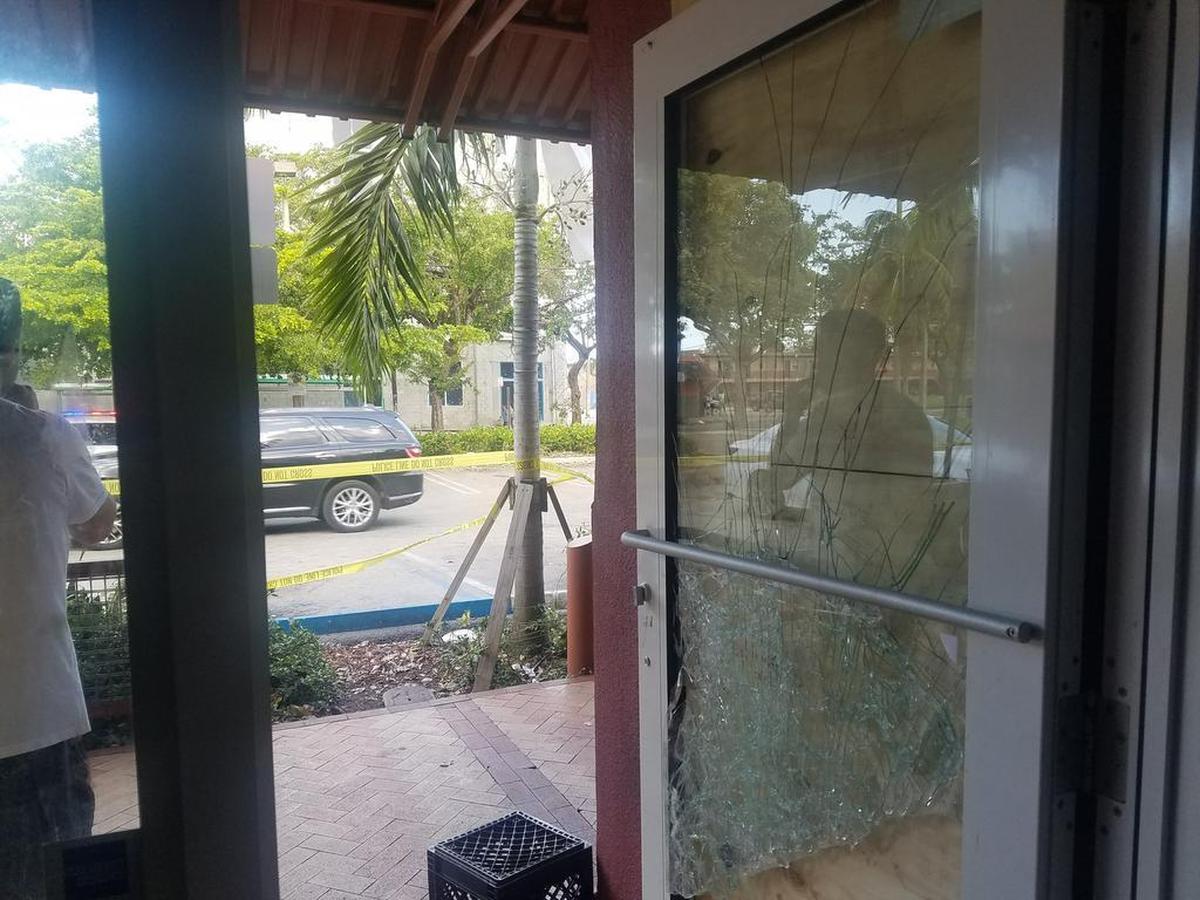 The smashed front door of a beauty supply store in Overtown that was broken into and robbed during Hurricane Irma.