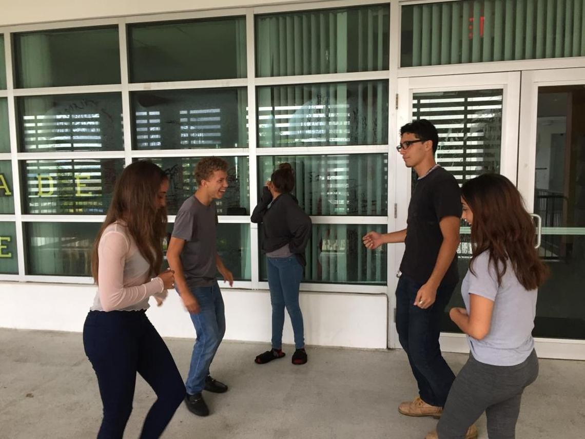 Teens dance to salsa music to pass the time at South Dade Middle School on Saturday, Sept. 9. The school served as a shelter during Hurricane Irma.