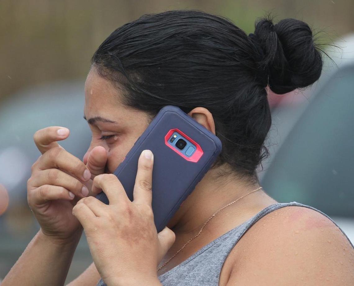 A woman breaks into tears as she finally reaches relatives on the U.S. mainland. About forty vehicles pulled to the shoulder as locals tried to place calls to the U.S. mainland near a cell tower outside of Dorado on PR22 in Puerto Rico on Saturday.