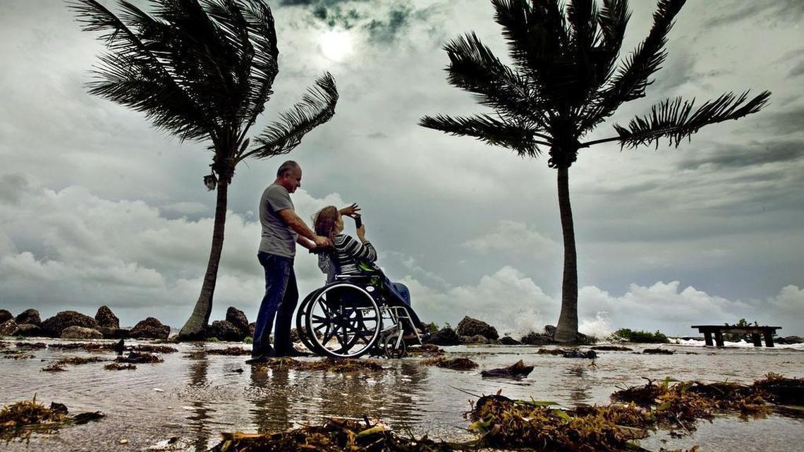 
Luis Duero and his wife, Ana Garrido Duero, of South Miami take pictures and watch what's left of Tropical Storm Erika at Matheson Hammock Park on Sunday Aug. 30, 2015.
