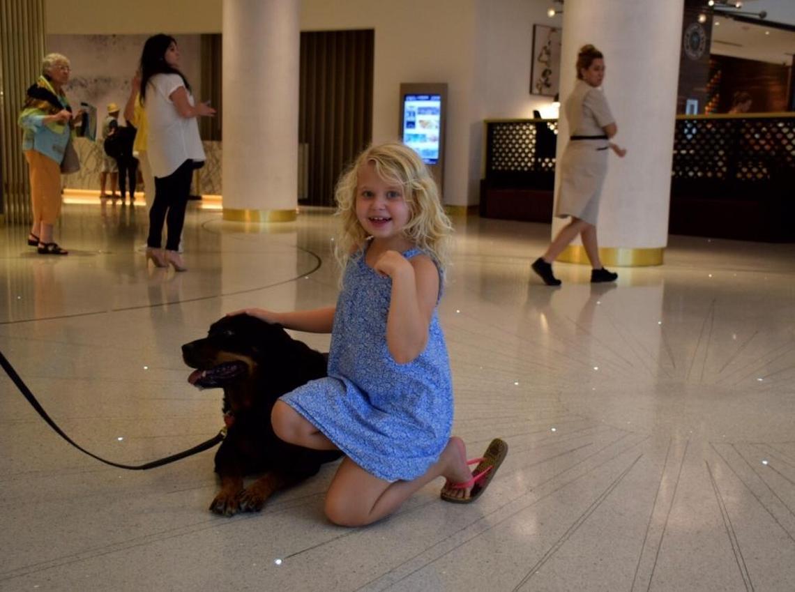 Allegra Orlofsky, 7, poses with her 9-year-old rottweiler Cruella at the Loews Miami Beach hotel Thursday.
