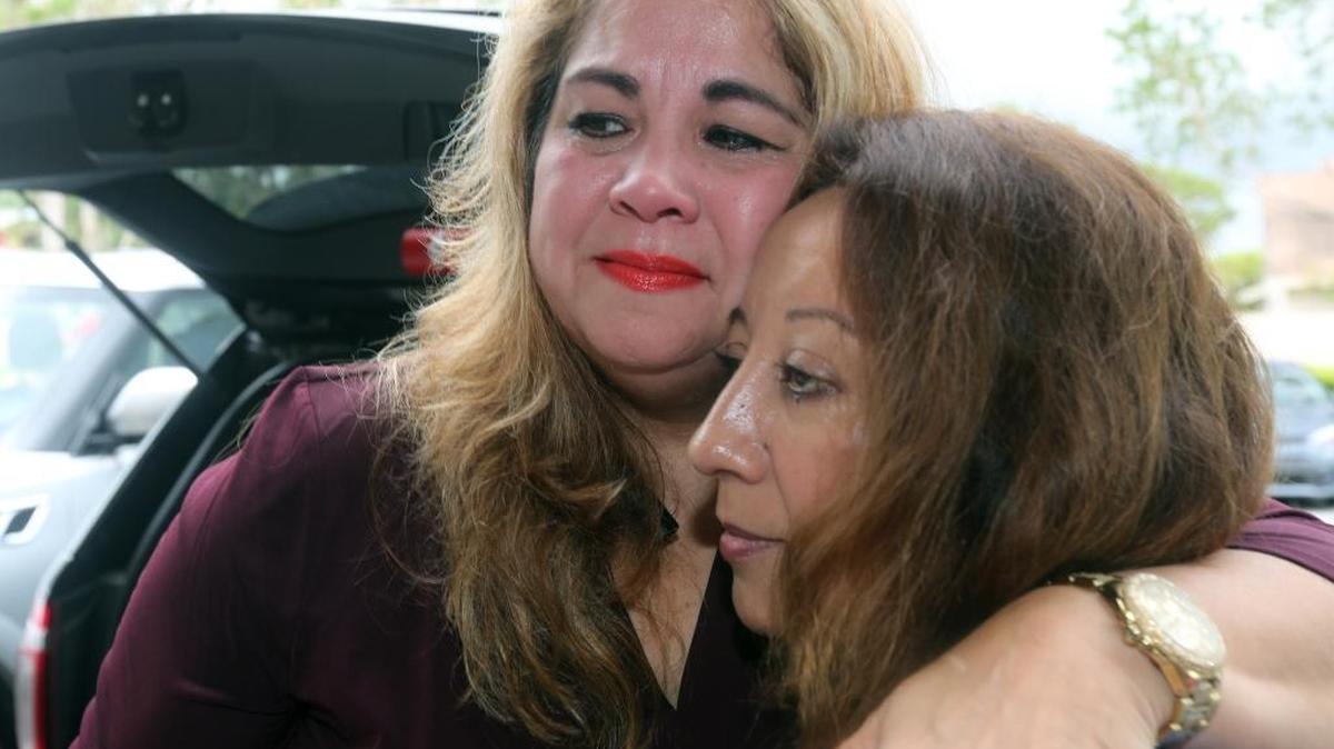 Elizabeth Guerrero Laracuente hugs Magnolia Acosta. Guerrero, a Kendall real estate agent, has been insistently trying — and failing — to reach her 72-year-old mother on the hurricane-ravaged island for three days, virtually ‘round the clock. .