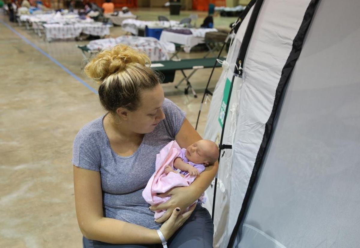 Dana Zwally, 23, holds her week-old baby Alayna outside of their privacy tent at the E. Darwin Fuchs Pavilion at the Miami-Dade Fairgrounds, Thursday, Sept. 14, 2017. Zwally evacuated her Key West home with her family prior to Hurricane Irma's arrival and gave birth to Alayna at Baptist Hospital last Thursday at midnight.