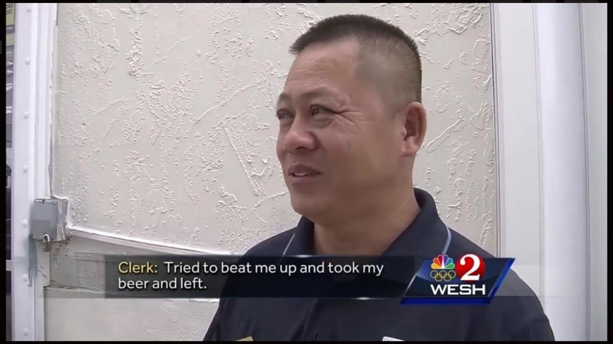 Cocoa, Florida store owner Sowann Suy, who said he felt threatened that he was about to be beaten up, is seen in a screengrab from a WESH 2 News report that he chased off a thief at gunpoint on Sept. 20. He forced the man, who had beer in each pocket, to give back the stolen brew.