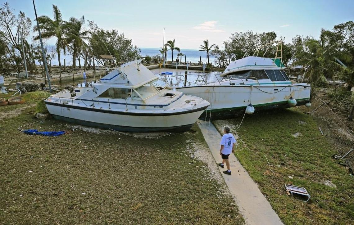 Chris Morgan walks toward two large boats that Irma’s powerful winds pushed onshore in Key Largo.